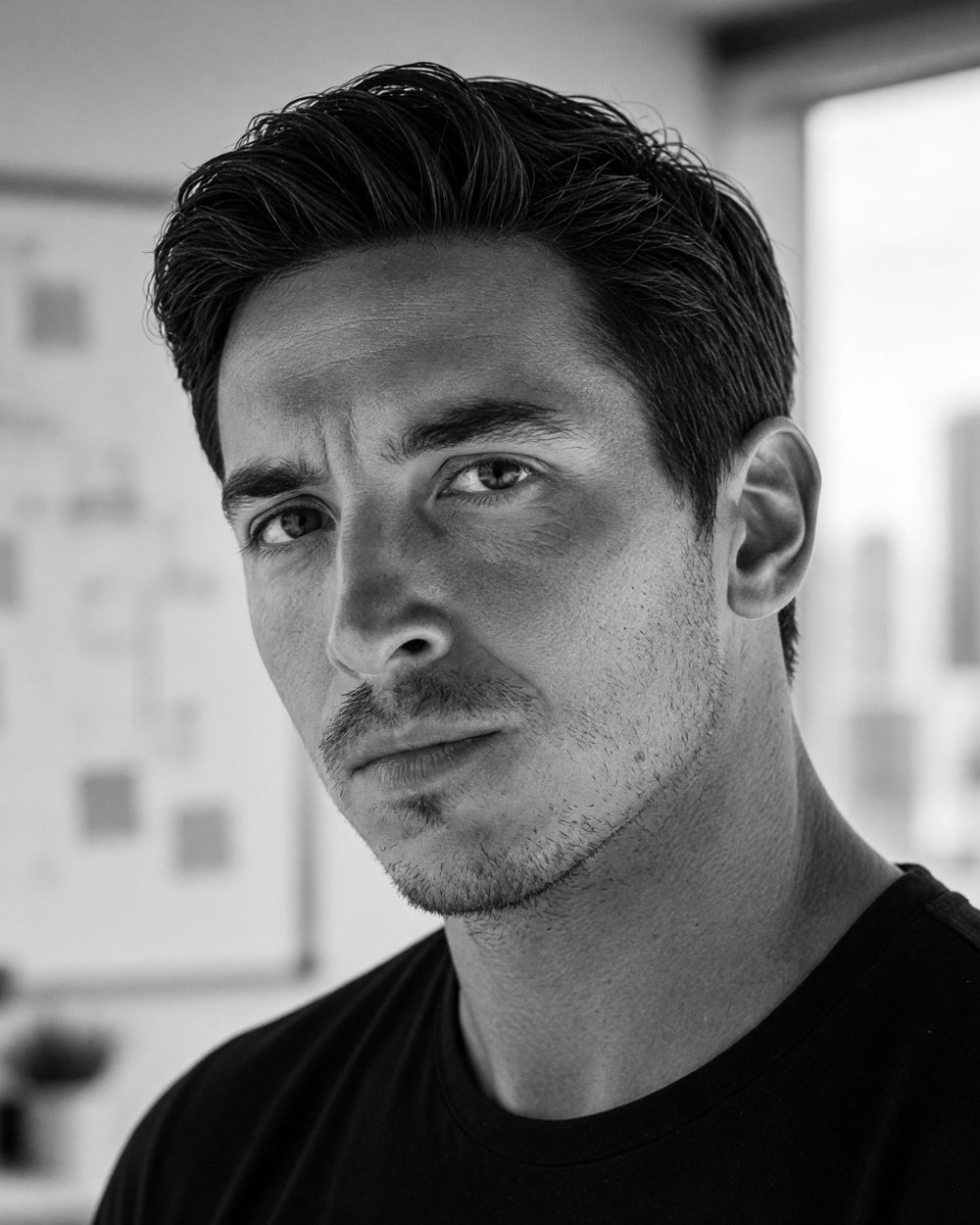 Marco, fondateur de Ton appli, portrait en noir et blanc devant un tableau de travail